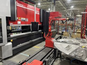 Amada HG 1003 press brake (automated bending cell) operator-side view