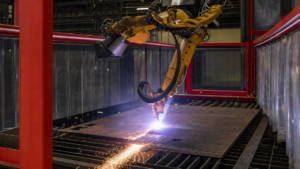 Structural robotic plasma cutting performing plasma cutting in a metal fabrication shop