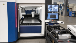 Enclosed CNC flat-sheet fiber laser cutting machine performing fiber laser cutting in a metal fabrication shop