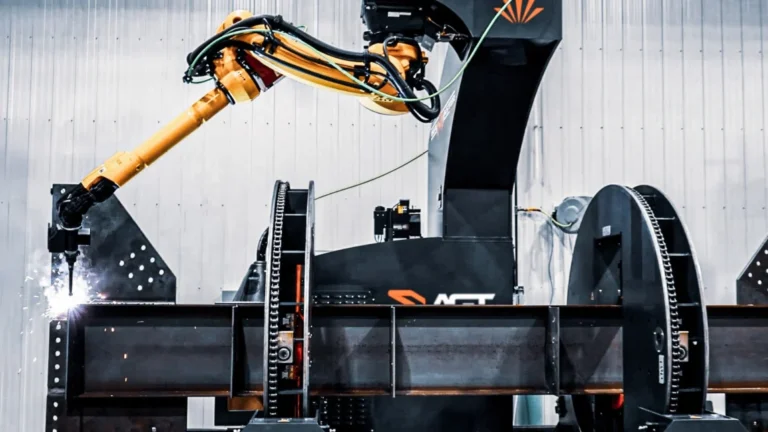 Robotic structural-steel welding systems performing AGT BeamMaster robotic structural-steel arc welding in a metal fabrication shop