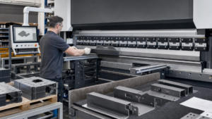 Press Brakes performing Laser-cut sheet-metal blanks entering CNC press-brake forming in a metal fabrication shop